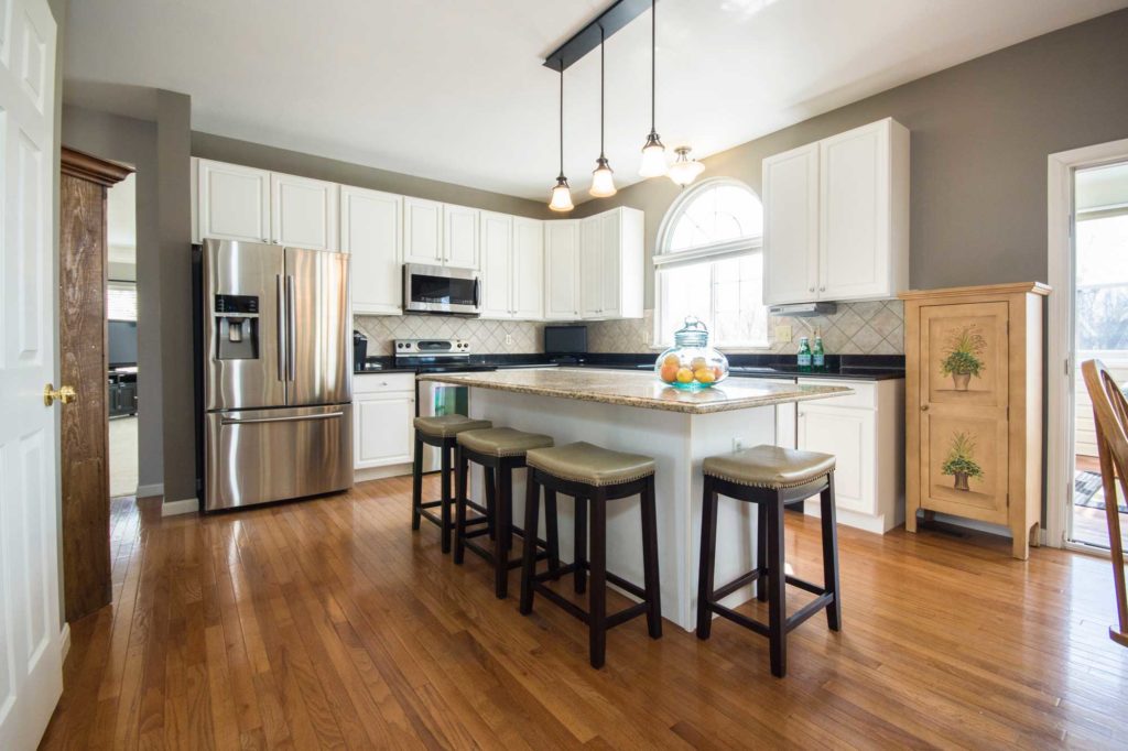 Country Style Kitchen with Island, Cabinets, and Wood Floors