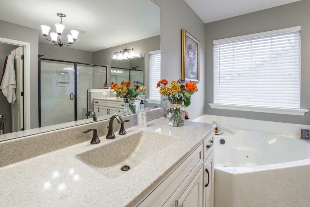 Custom Bathroom with Shower, Tub, and Granite Sink